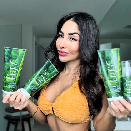 Woman holding FUYA Haircare Repair & Shine collection with green packaging – natural hair care brand photo