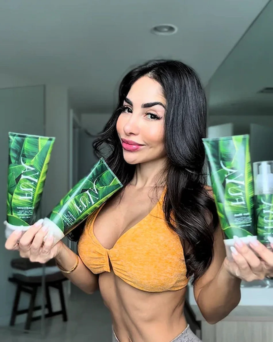 Woman holding FUYA Haircare Repair & Shine collection with green packaging – natural hair care brand photo